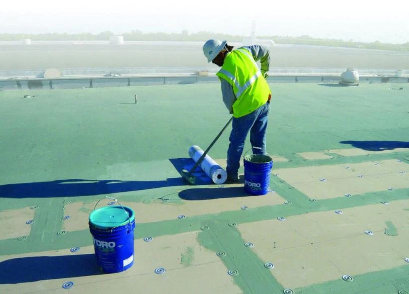 A roofer performs hydrostop coating services in New Jersey