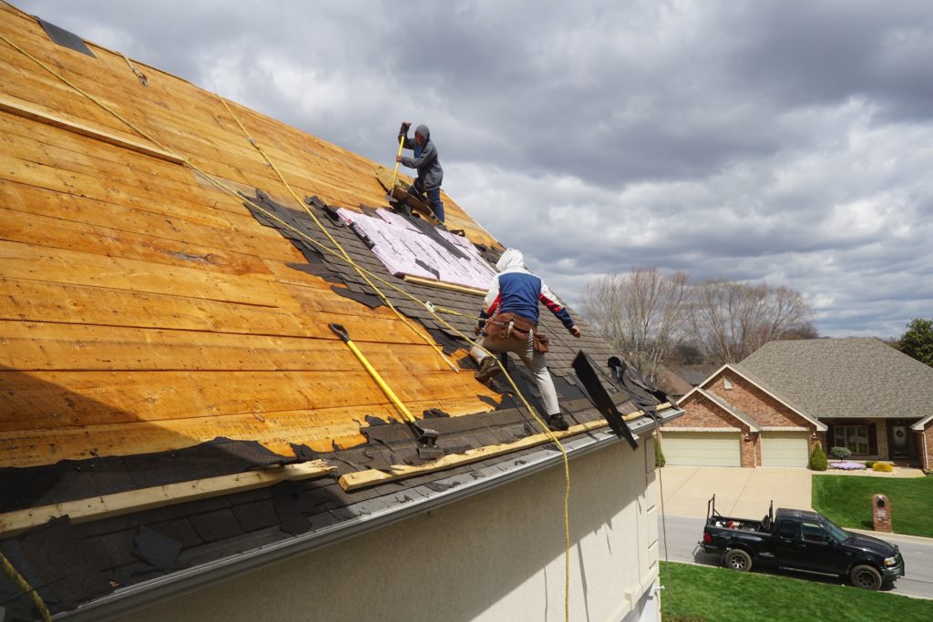 Two roofers are performing Roof Shingles Installation