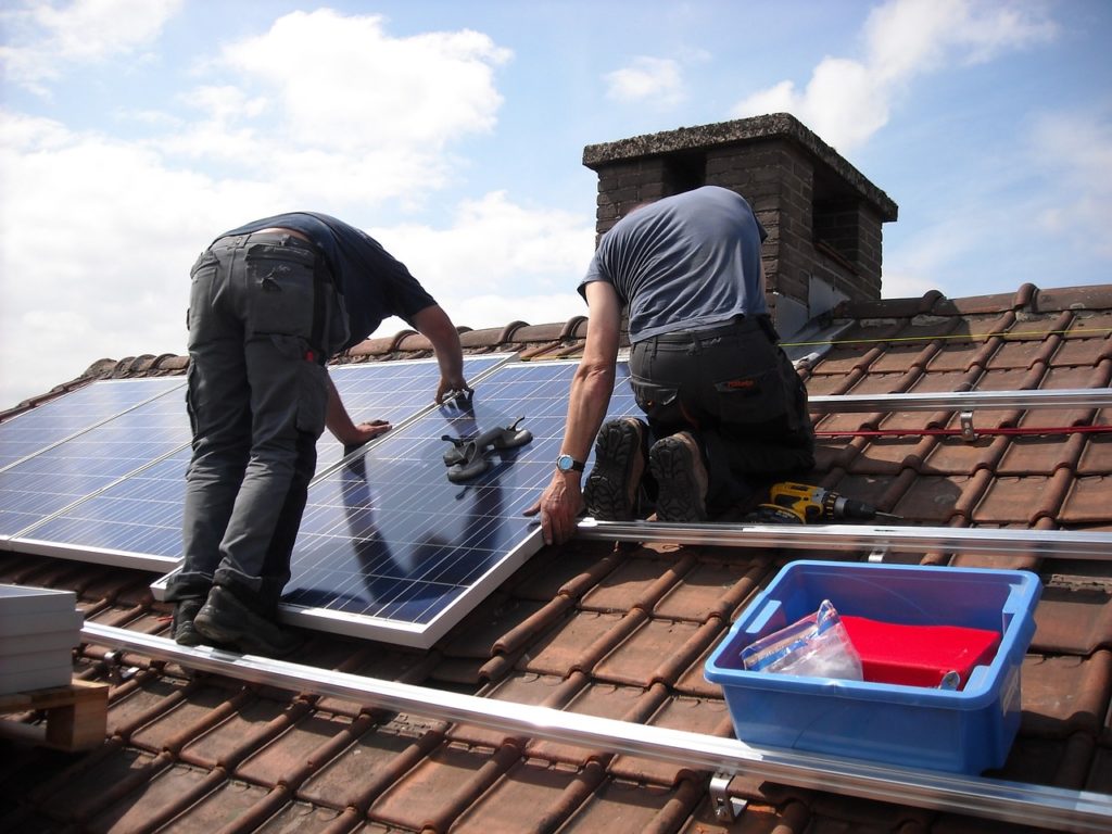 two professionals are doing solar roof installation